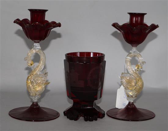 A pair of ruby swan glass candlesticks and an etched tumbler